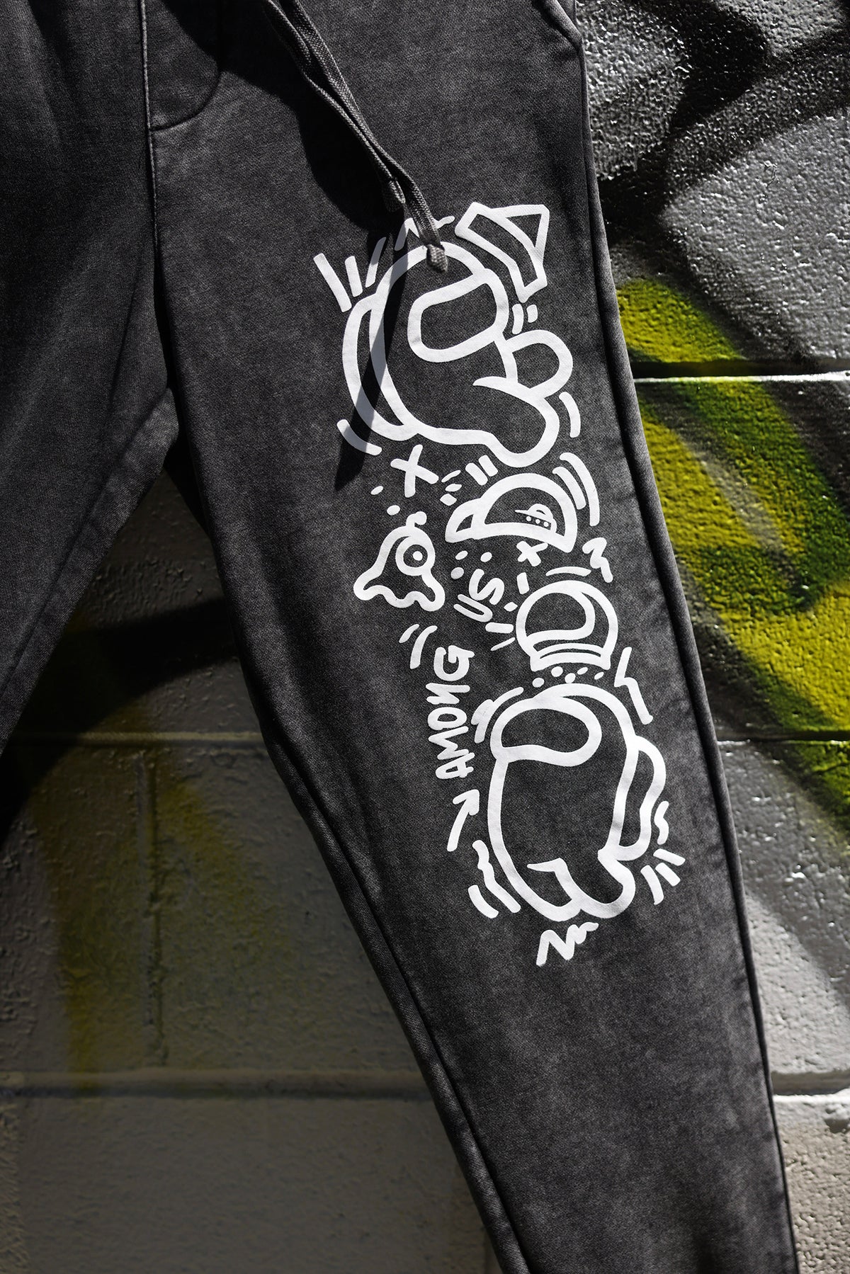 A zoomed in close up shot of the screenprinted Crewmate pattern against a graffitied background.
