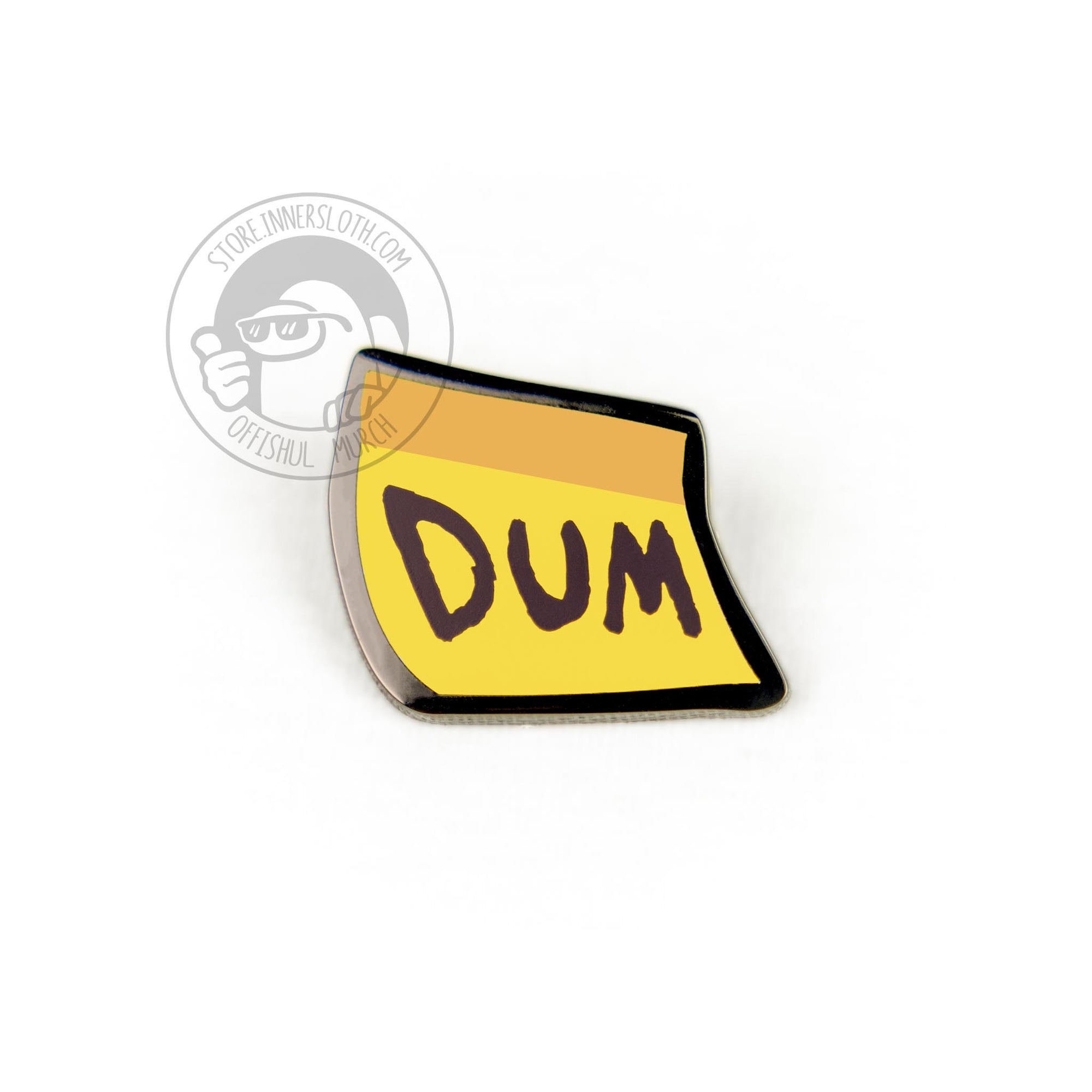 An enamel pin of the yellow sticky-note visor cosmetic on a white background. DUM is written in large letters across the front of the note.