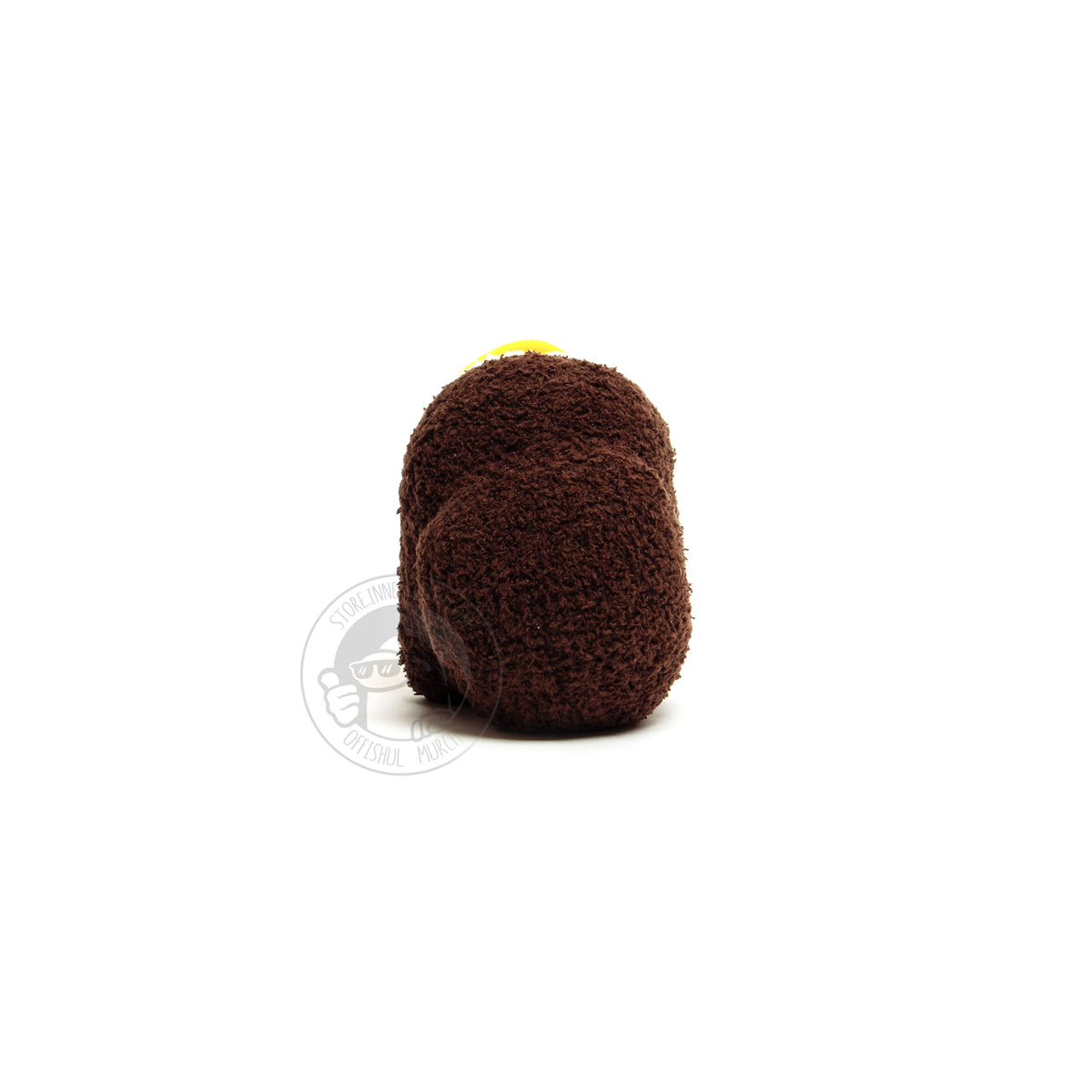 A back-view photograph of a small, brown, fuzzy, Crewmate  on a white background. From this angle you can see the Crewmate’s big, round, and thick backpack in full view.