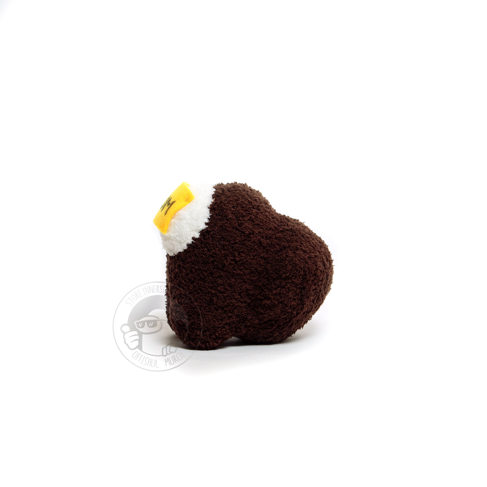 A front-facing product photograph of a small, brown, fuzzy, Crewmate plush with a felted DUM sticky note hanging over their visor by Naomi Sun on a white background. 