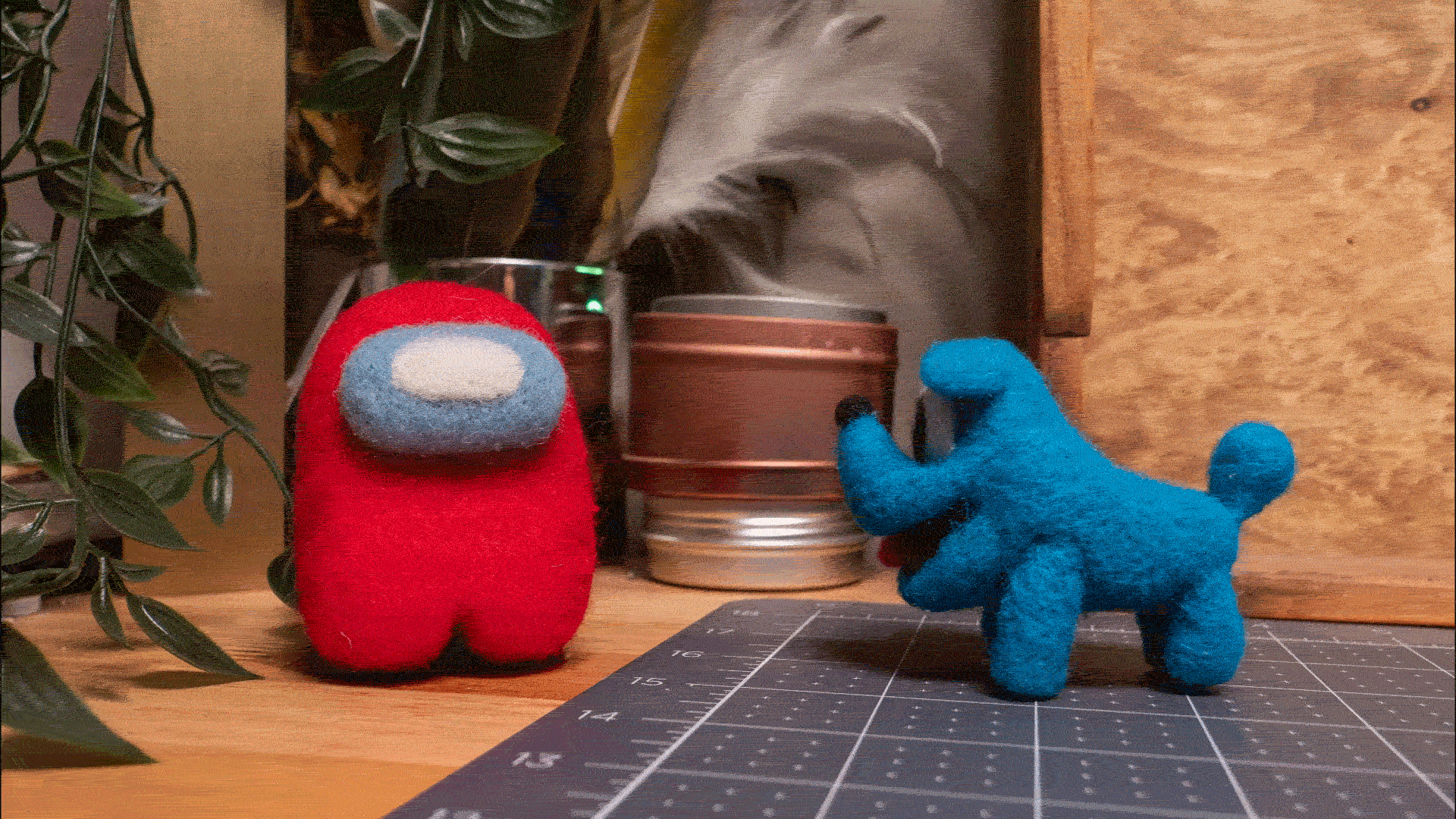 An animated gif of the Amarte Studio Needle Felted Crewmate riding away on the felted blue space dog.