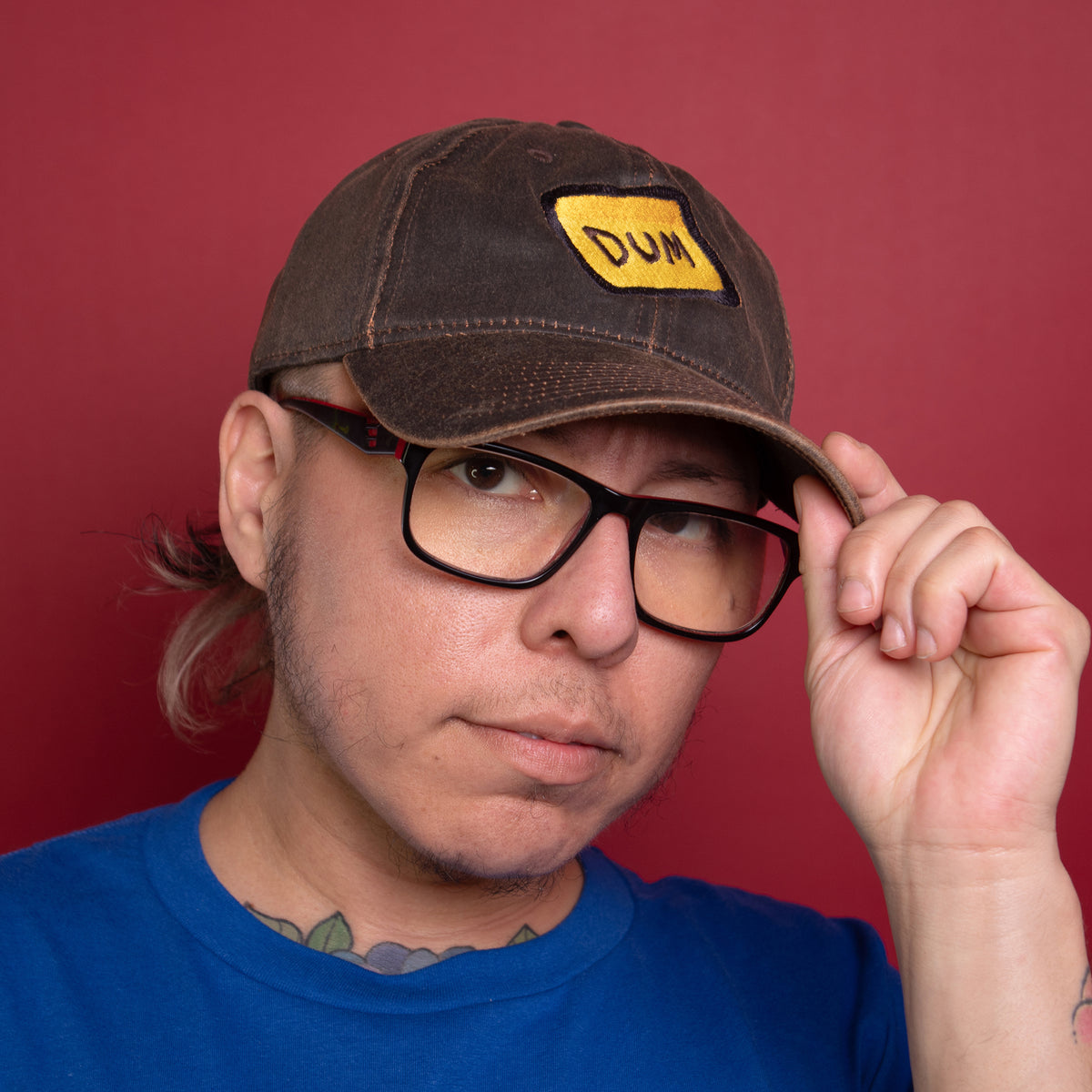  A three-quarter headshot of a model wearing the Brown DUM hat