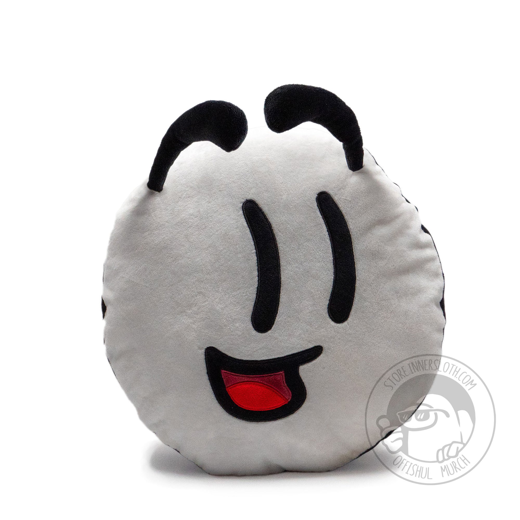 A photograph of the Henry Stickmin Face pillow on a white background. The pillow base color is white and the overall shape is a flat circular cushion with additional sewn in details. There are two raised apostrophe-like black eyebrows on either side of the pillow, two slightly curved black slits for eyes, and an upturned open mouth smile revealing an inner red mouth and tongue. Designed by PuffballsUnited and Amy Liu.