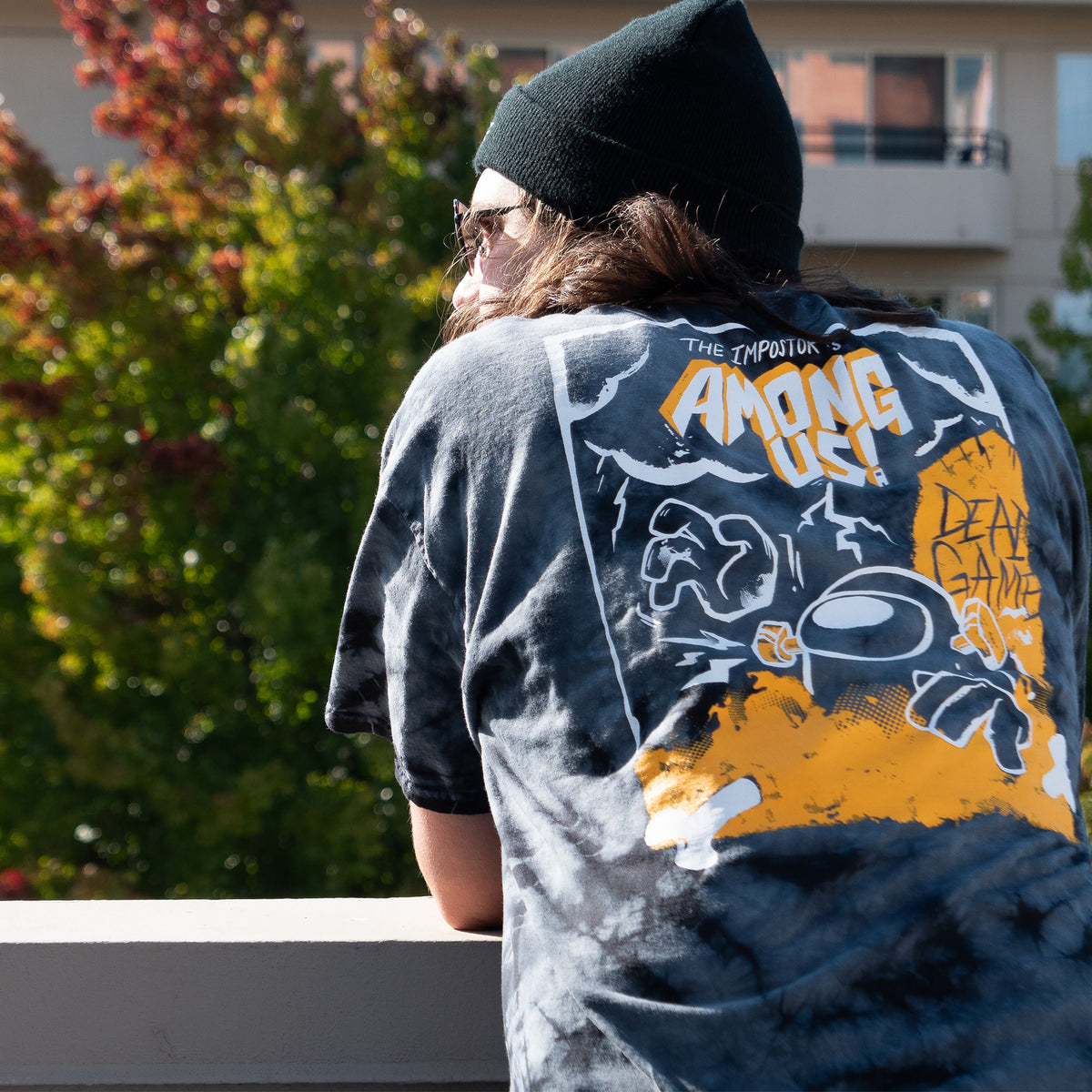 A three-quarter view shot of a model showing off the back of the Dead Game Shirt. 