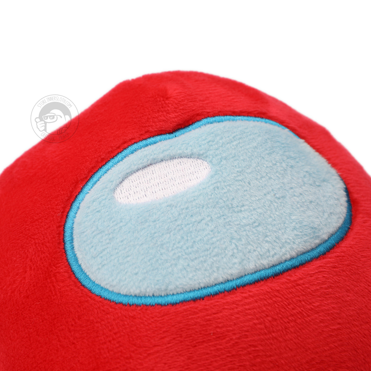 A closeup of the red Crewmate Plush’s soft light blue visor, with embroidered blue detail around the visor and white embroidery in the shine.