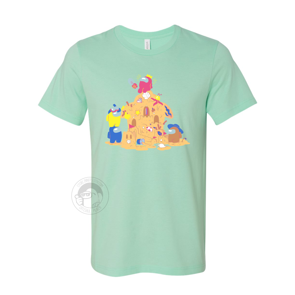  A product photo of the Among Us: Sandcastle Tee in Mint. The t-shirt is pistachio green and shows four crewmates building a sandcastle, which vaguely resembles the Airship. A pink crewmate wearing a crown hat sits at the top of the castle. 