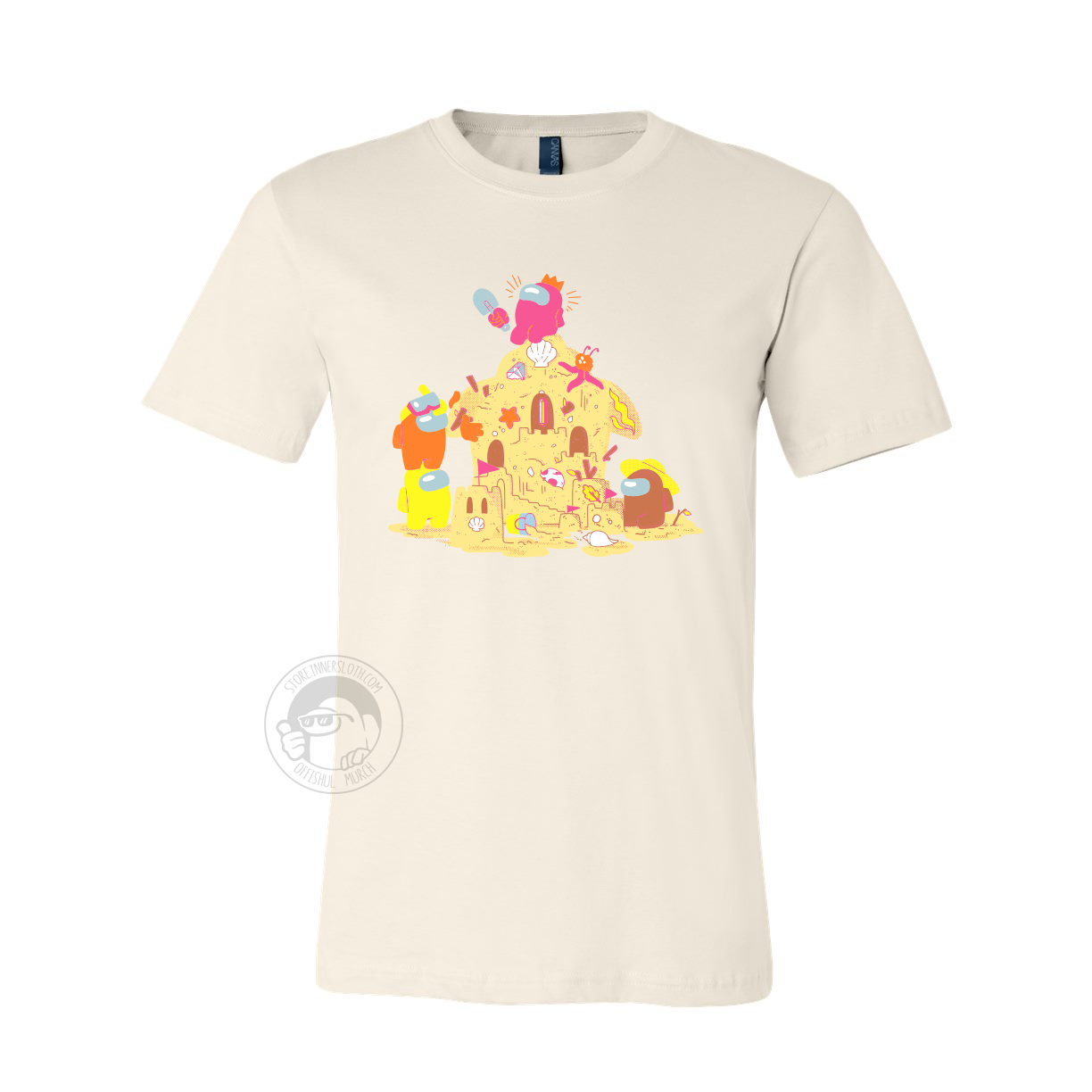 A product photo of the Among Us: Sandcastle Tee in Natural. The t-shirt is light beige and shows four crewmates building a sandcastle, which vaguely resembles the Airship. A pink crewmate wearing a crown hat sits at the top of the castle.