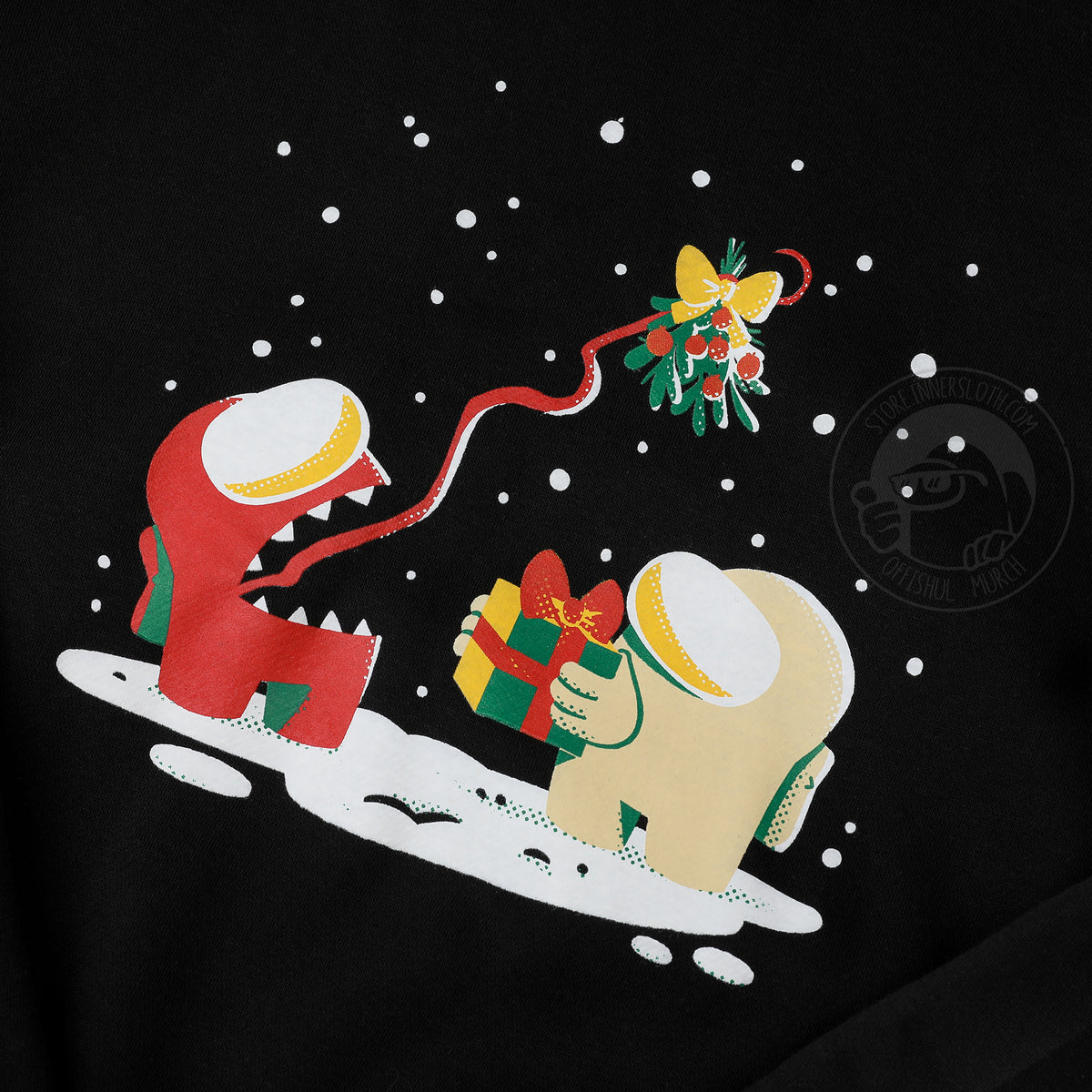 A close up photograph of the center shirt design. The illustration depicts a snowy scene of a banana Crewmate holding a wrapped gift while the red Impostor uses its tongue to hold up a mistletoe overhead.