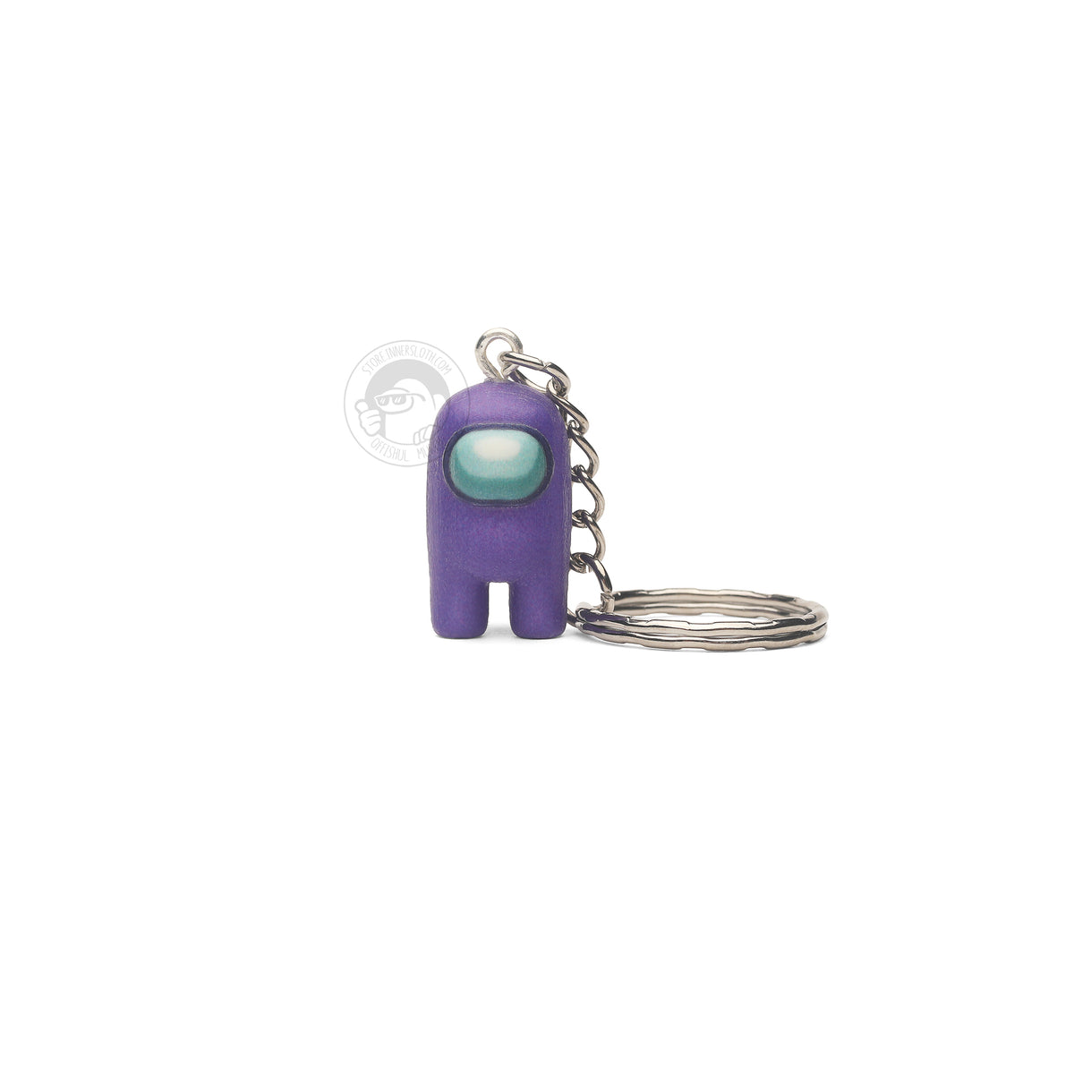 A product photo of the Among Us: Crewmate Keychain by Objex Unlimited Inc. in purple. It is standing, and a silver keychain rests beside it.