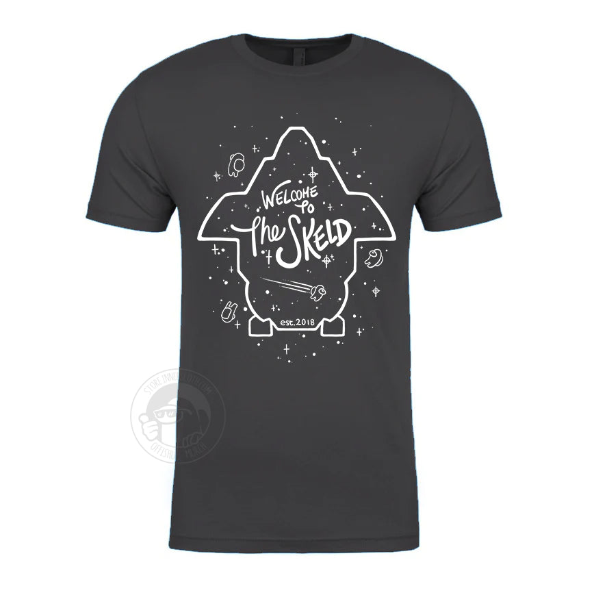 A product photo of the Among us: Welcome to The Skeld Tee in grey. The white lineart on the shirt outlines the perimeter of the Skeld game map, with white stars and small crewmates sprinkled around it.