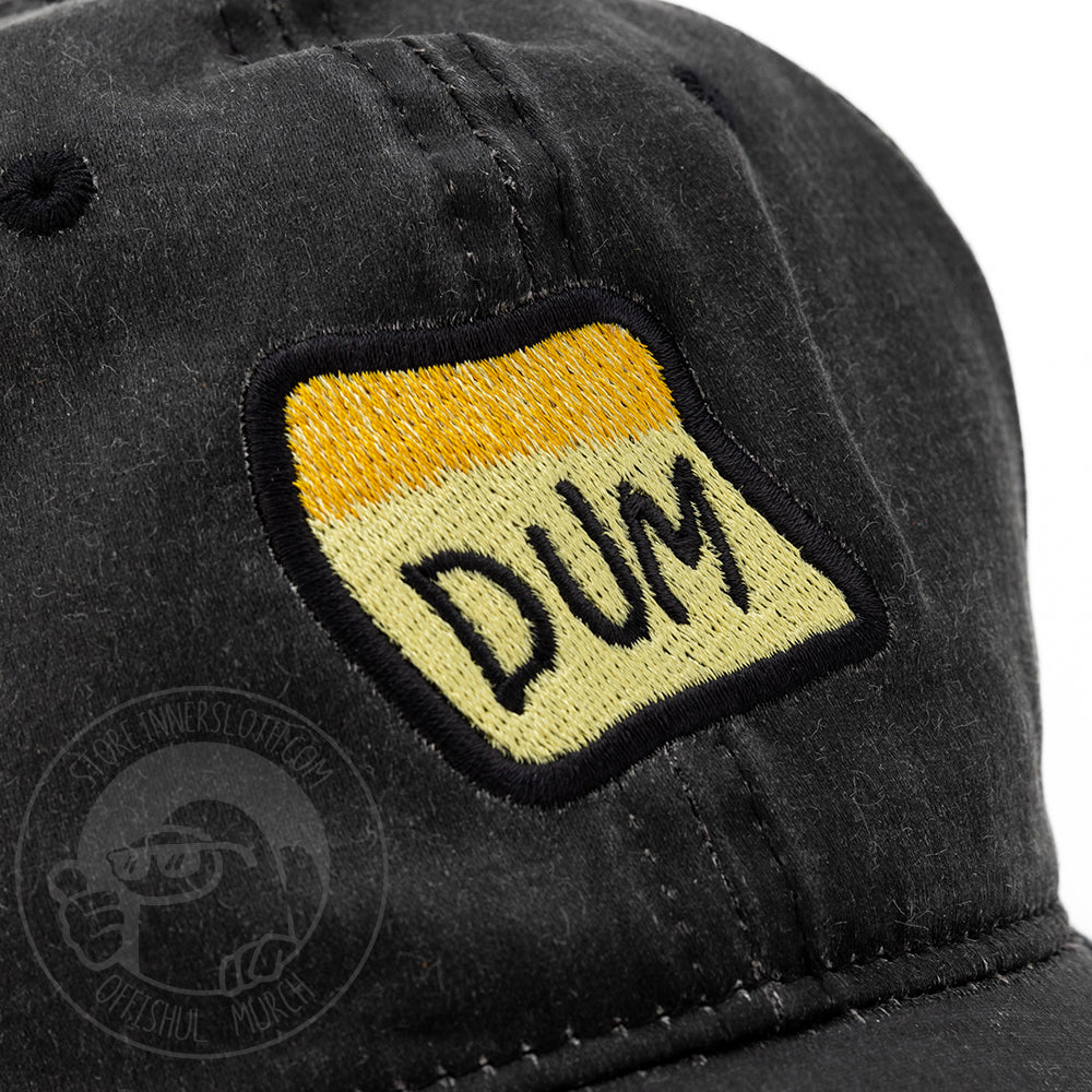 Zoomed in photo of the black DUM hat to show embroidery detail