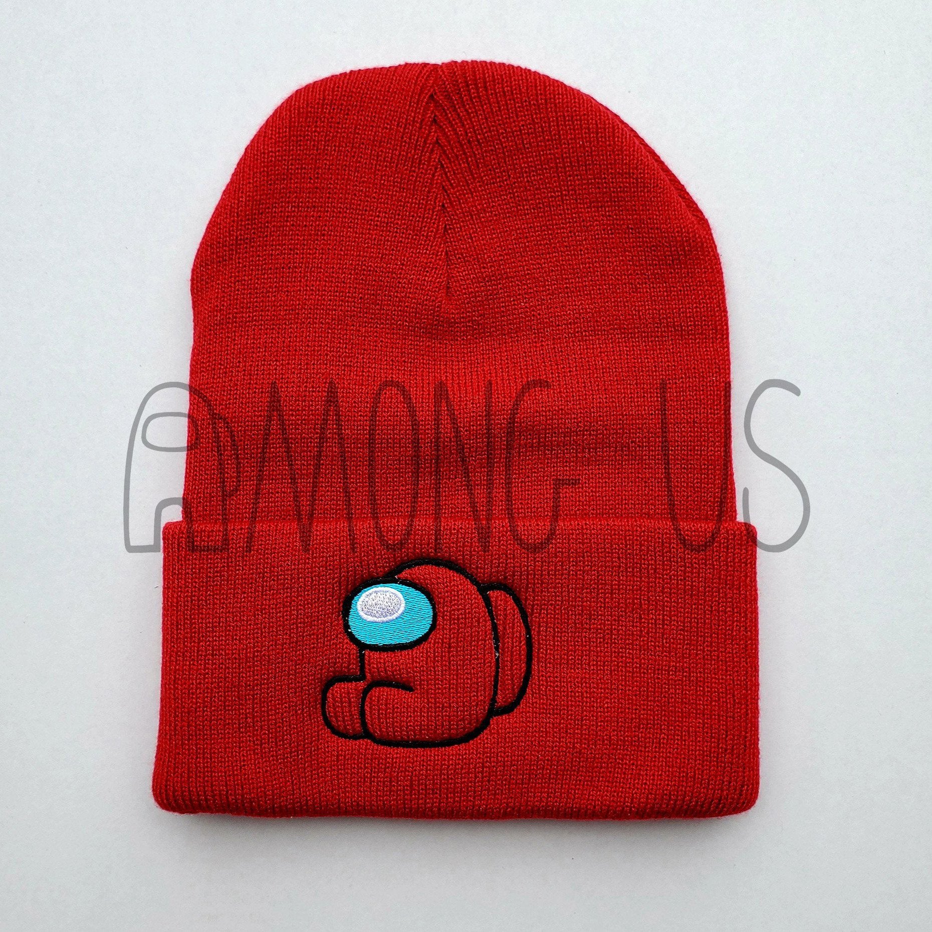 A flat lay photograph of the red Among Us: Crewmate Beanie. The brim of the beanie shows an embroidered sitting red crewmate.