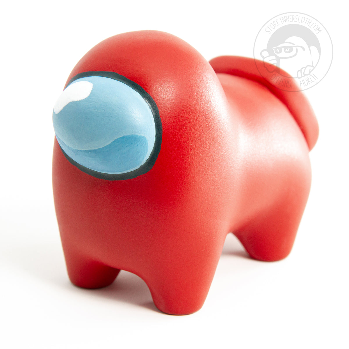 A ¾ view of the Crewgi Figurine reveals its back legs, for a total of four, and a backpack placed squarely on its bum. A light shines on the red color, revealing a beautiful matte texture.