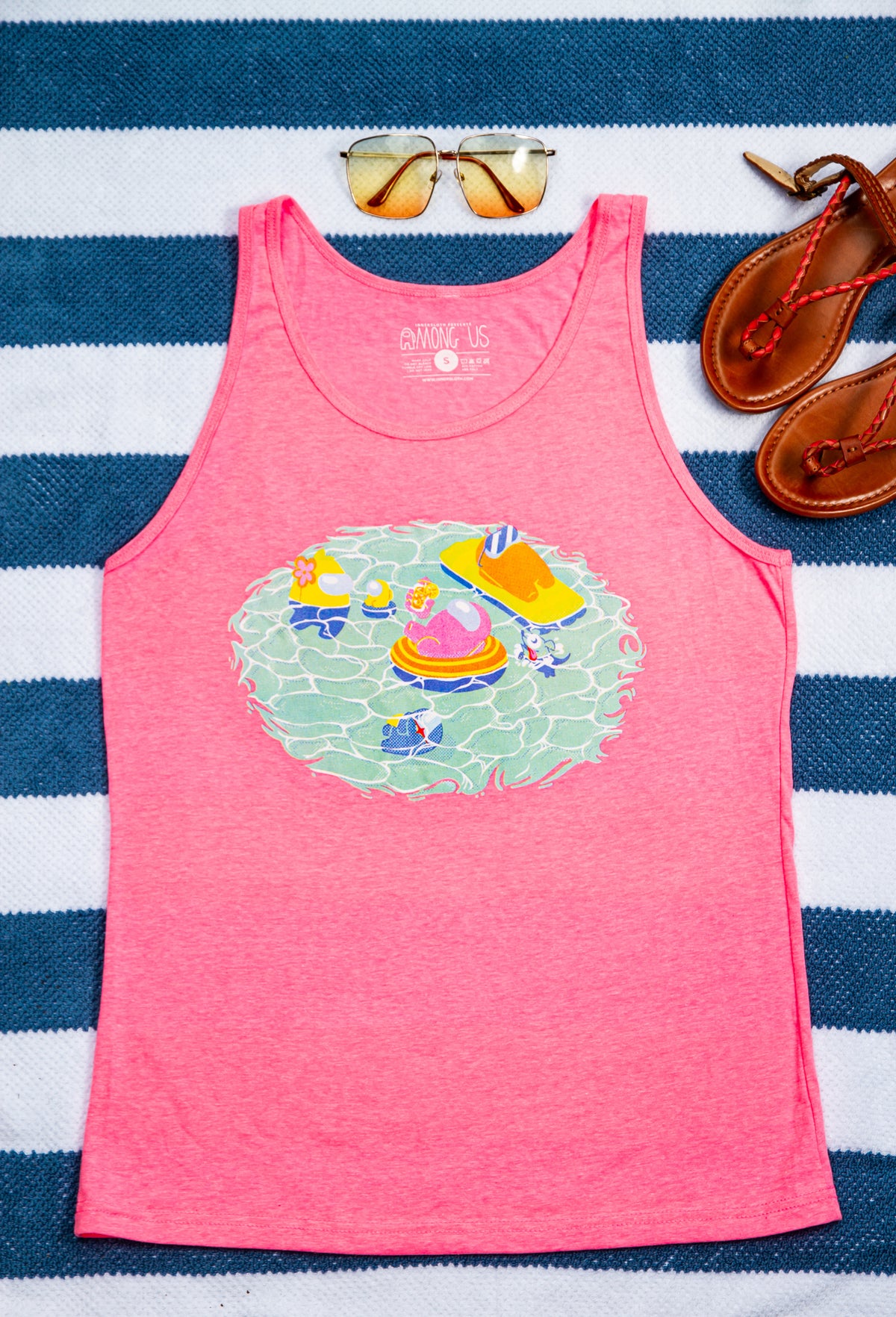 A photo of the Among Us: Swimming Pool Tank Top, laying on a nautical towel.