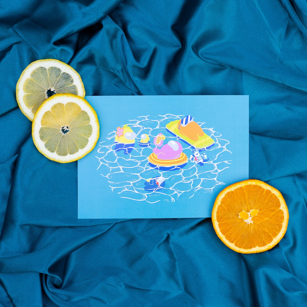 A photo of the blue pool print on blue fabric with citrus slices.